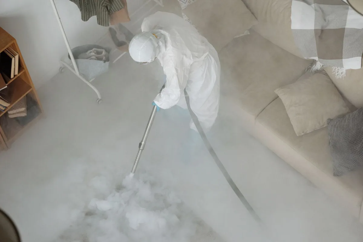 Biohazard cleanup technician in protective equipment, Taylor Creek, FL